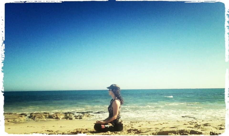 Jo meditating by the beach